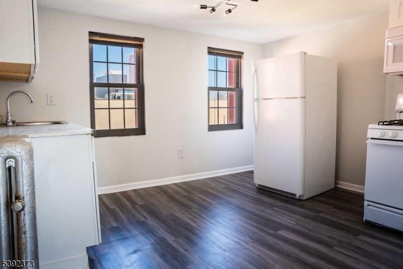 5 Elm Street, Unit 4 Newark, NJ 07102 - Photo 2 of 11 a view of a kitchen with wooden floor and a window