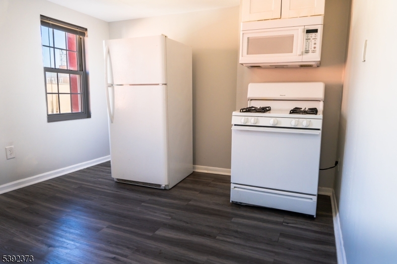 5 Elm Street, Unit 4 Newark, NJ 07102 - Photo 3 of 11 a view of washer and dryer with wooden floor