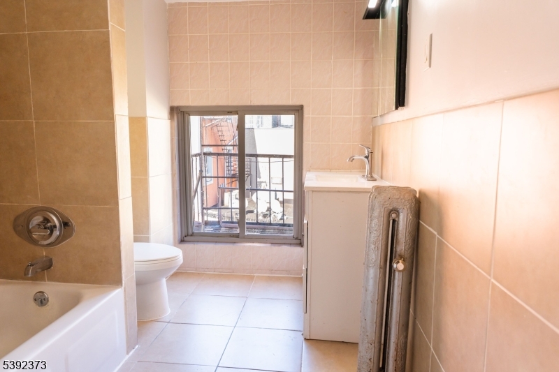 5 Elm Street, Unit 4 Newark, NJ 07102 - Photo 4 of 11 a bathroom with a bathtub sink and toilet