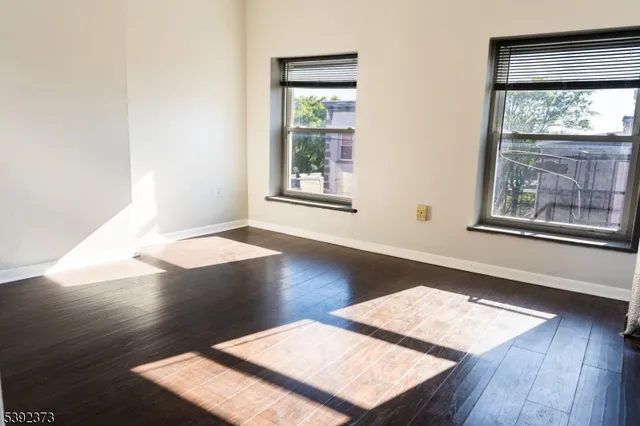 a view of a room with wooden floor and front door