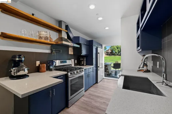 a kitchen with a stove a sink and a refrigerator
