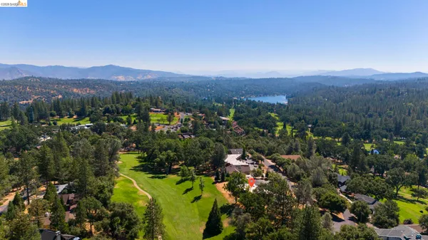 an aerial view of residential house with outdoor space and mountain view