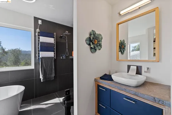 a bathroom with a granite countertop sink a toilet and mirror