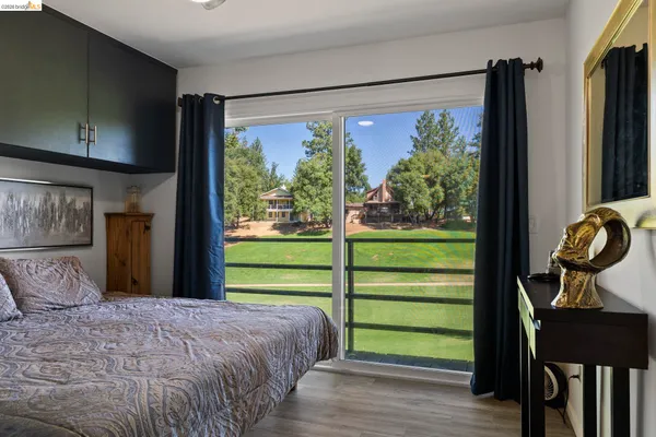 a bedroom with a bed window and a television