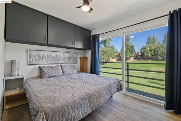a bedroom with a bed and a large window