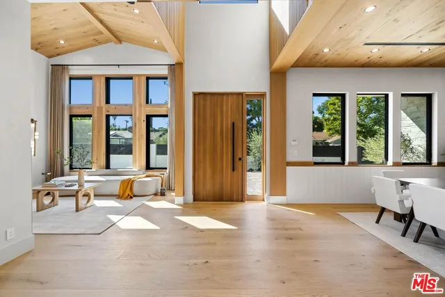 a living room with furniture and large windows