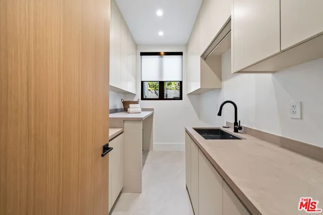 a kitchen with sink a window and appliances