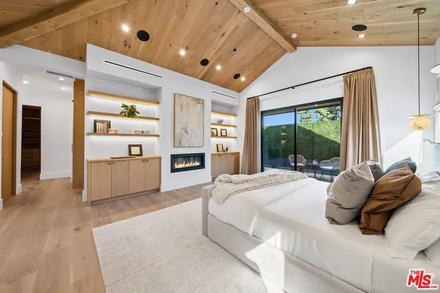 a large bedroom with a large bed and a large window