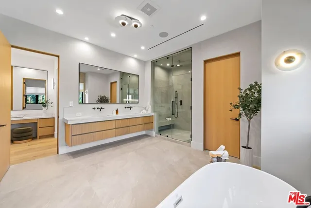 a bathroom with a sink tub shower and a mirror
