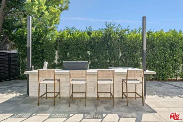 a view of a chairs and table in a backyard