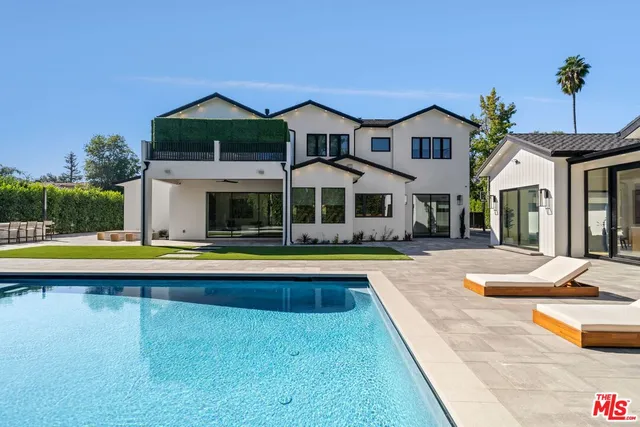 a view of a house with swimming pool and porch
