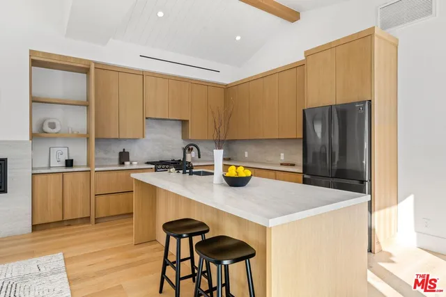 a kitchen with a sink a stove a refrigerator and cabinets