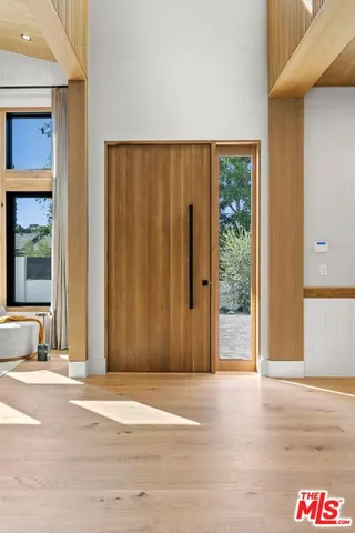 a view of a room with wooden floor and window