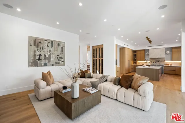 a living room with furniture and kitchen view
