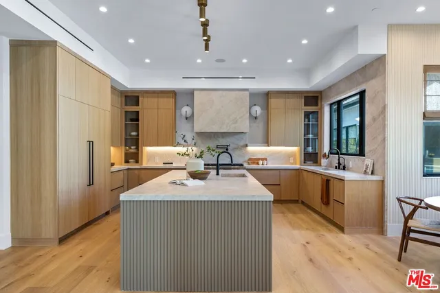 a large kitchen with kitchen island a sink stainless steel appliances and cabinets