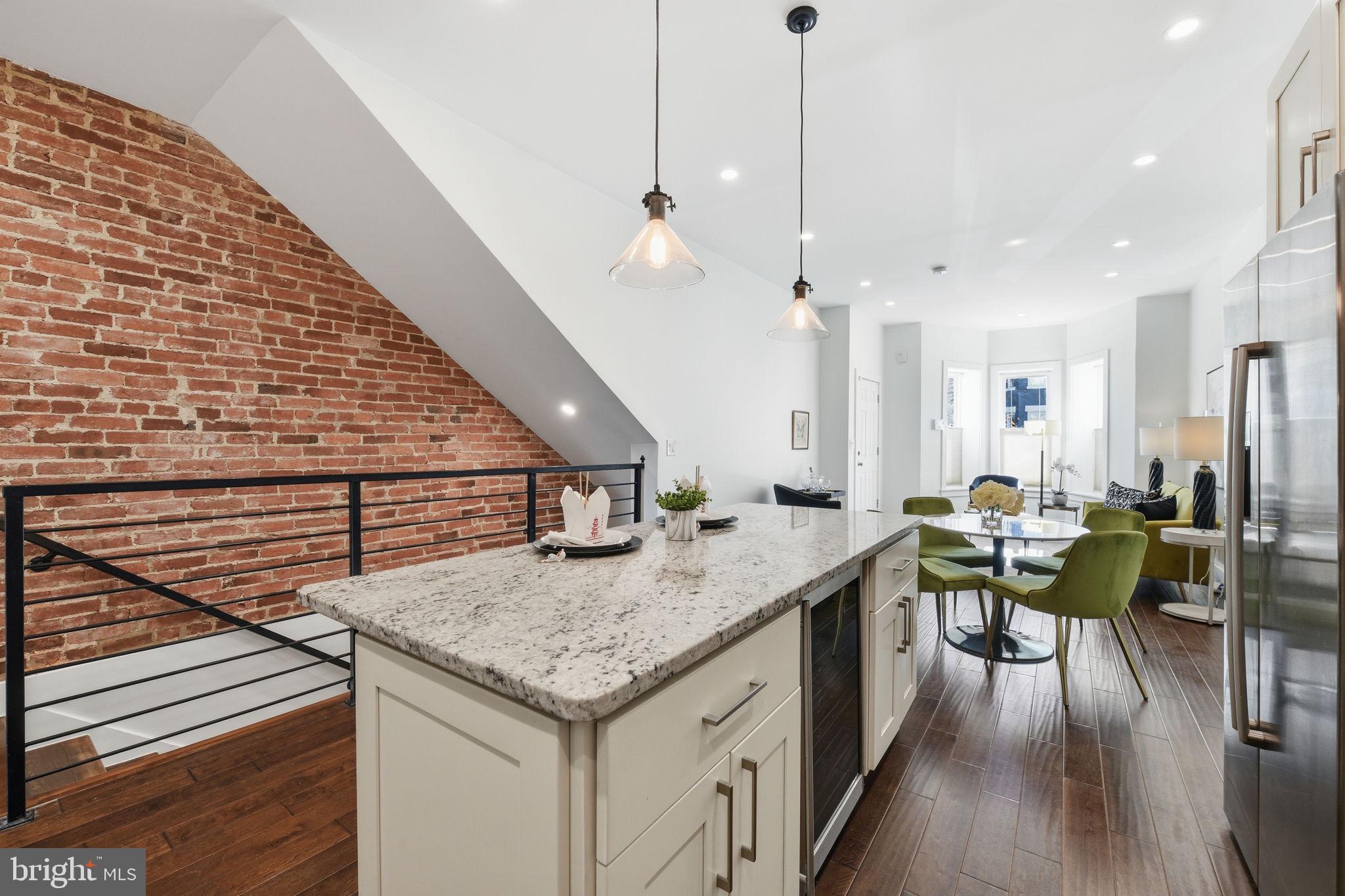 26 Q Street Northeast, Unit 1 Washington, DC 20002 - Photo 12 of 36 a kitchen with a table chairs and white cabinets