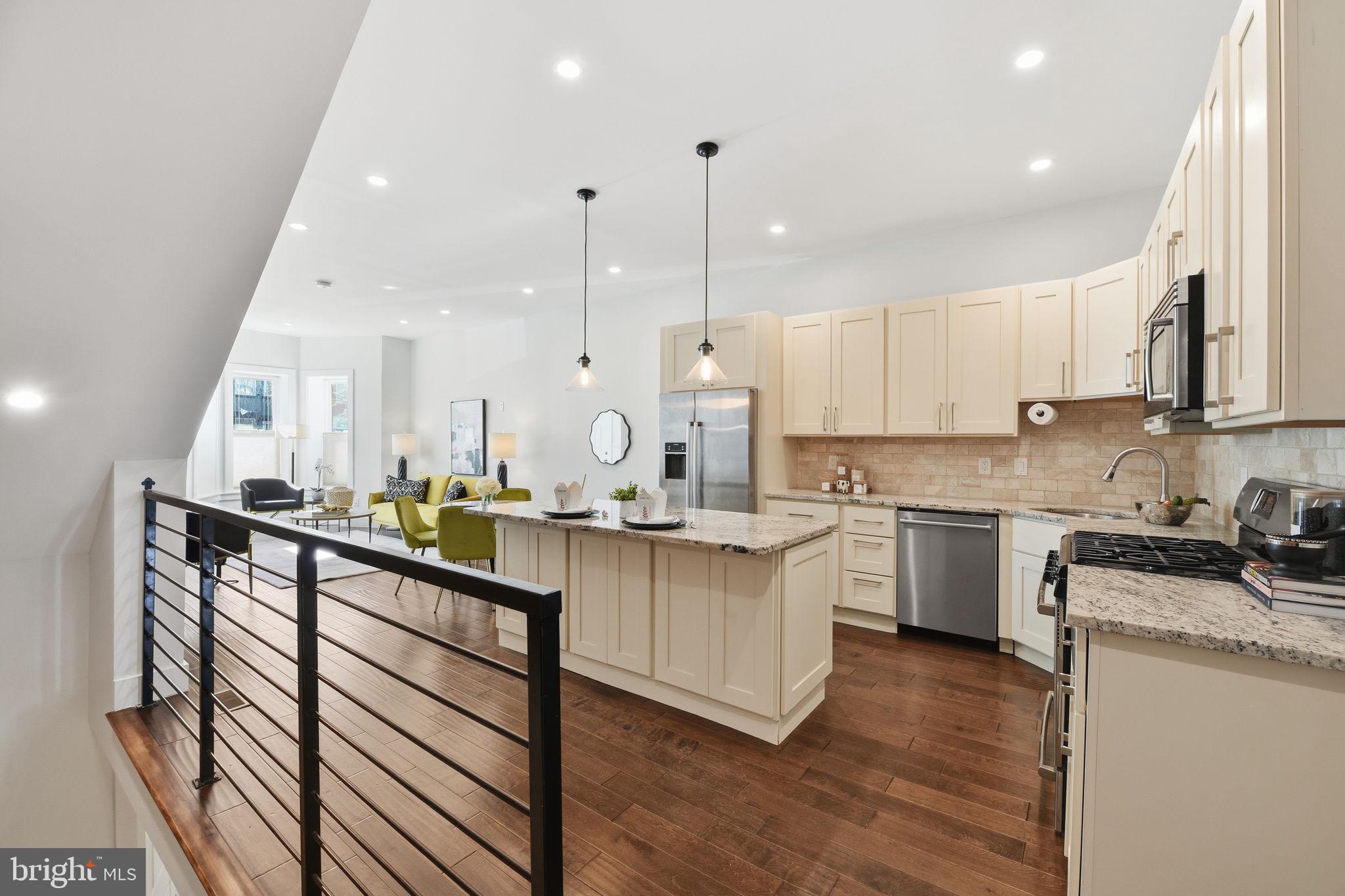 26 Q Street Northeast, Unit 1 Washington, DC 20002 - Photo 13 of 36 a kitchen with stainless steel appliances granite countertop a sink a stove and cabinets