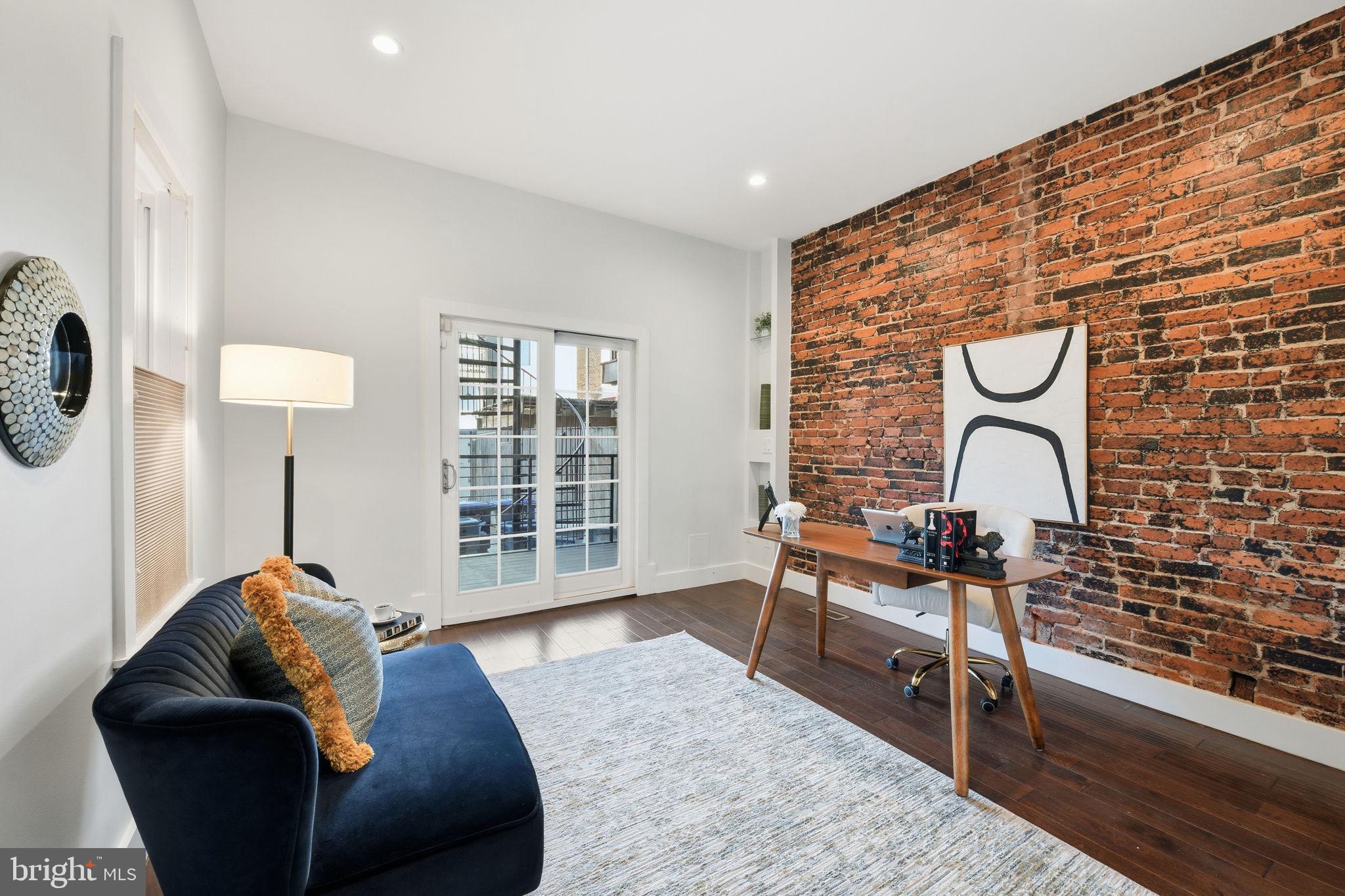 26 Q Street Northeast, Unit 1 Washington, DC 20002 - Photo 16 of 36 a living room with furniture and a window