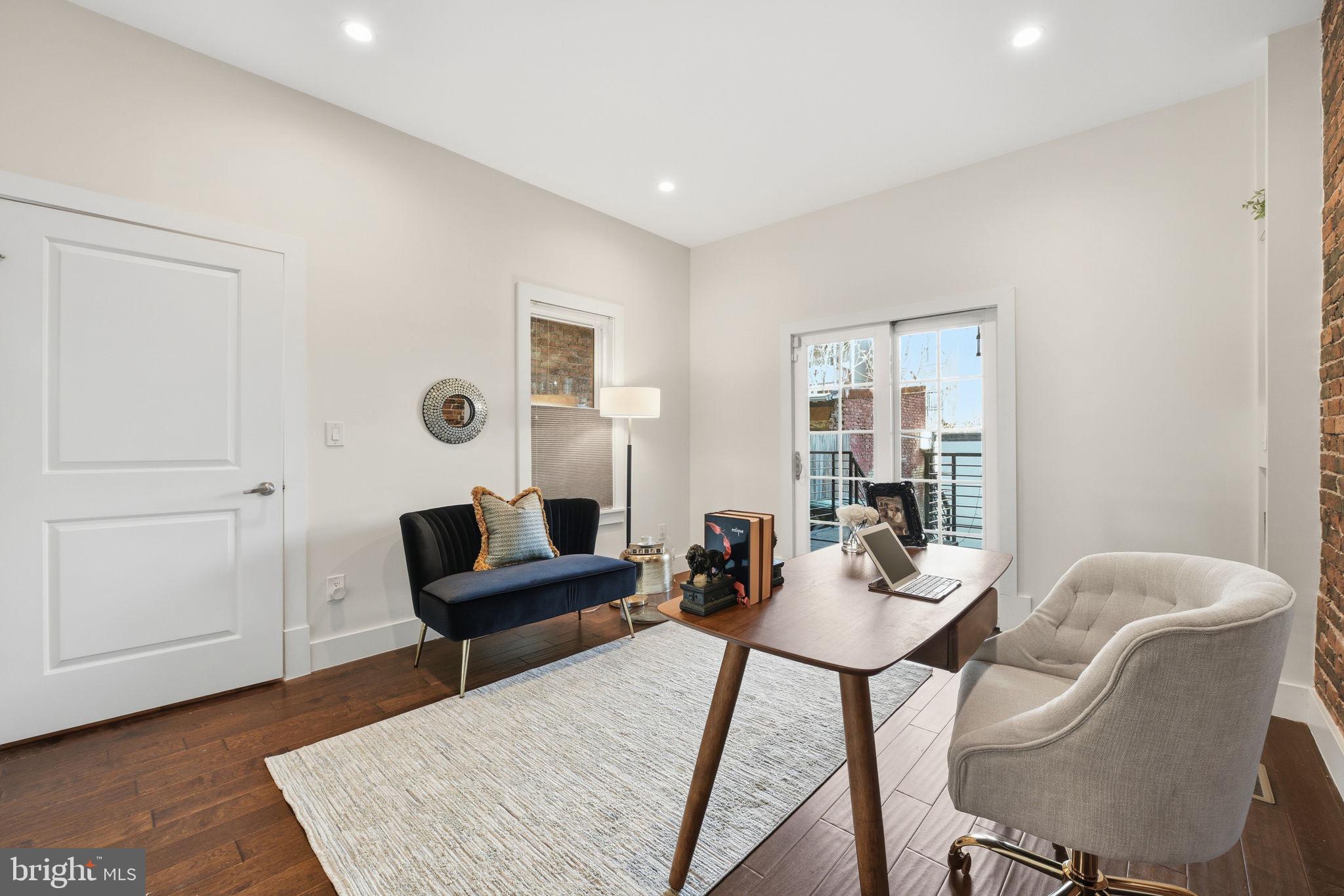 26 Q Street Northeast, Unit 1 Washington, DC 20002 - Photo 17 of 36 a living room with furniture and wooden floor