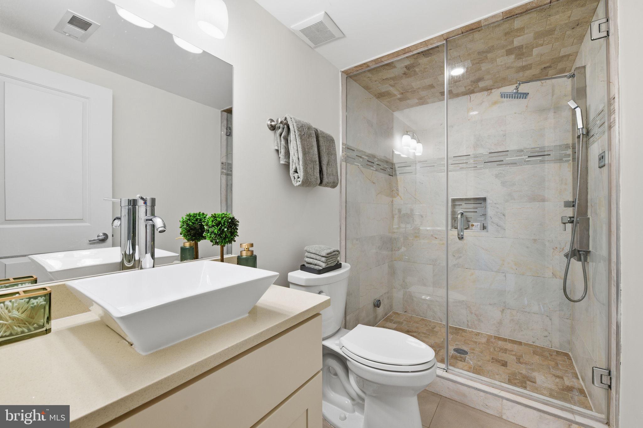 26 Q Street Northeast, Unit 1 Washington, DC 20002 - Photo 18 of 36 a bathroom with a sink toilet and shower