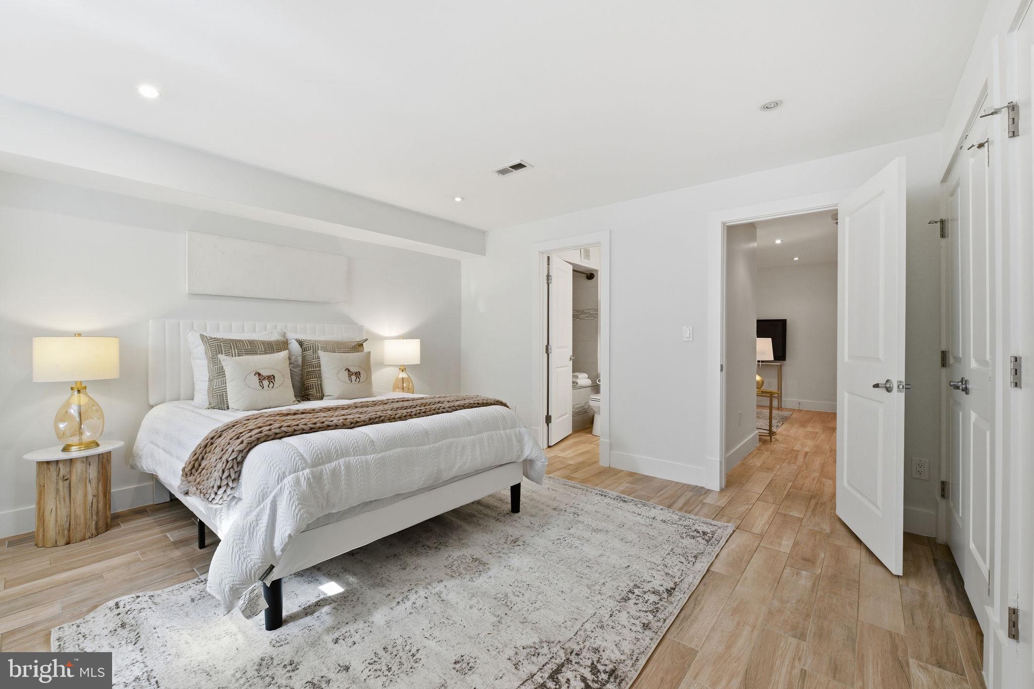 26 Q Street Northeast, Unit 1 Washington, DC 20002 - Photo 24 of 36 a bed room with a bed and a walk in closet