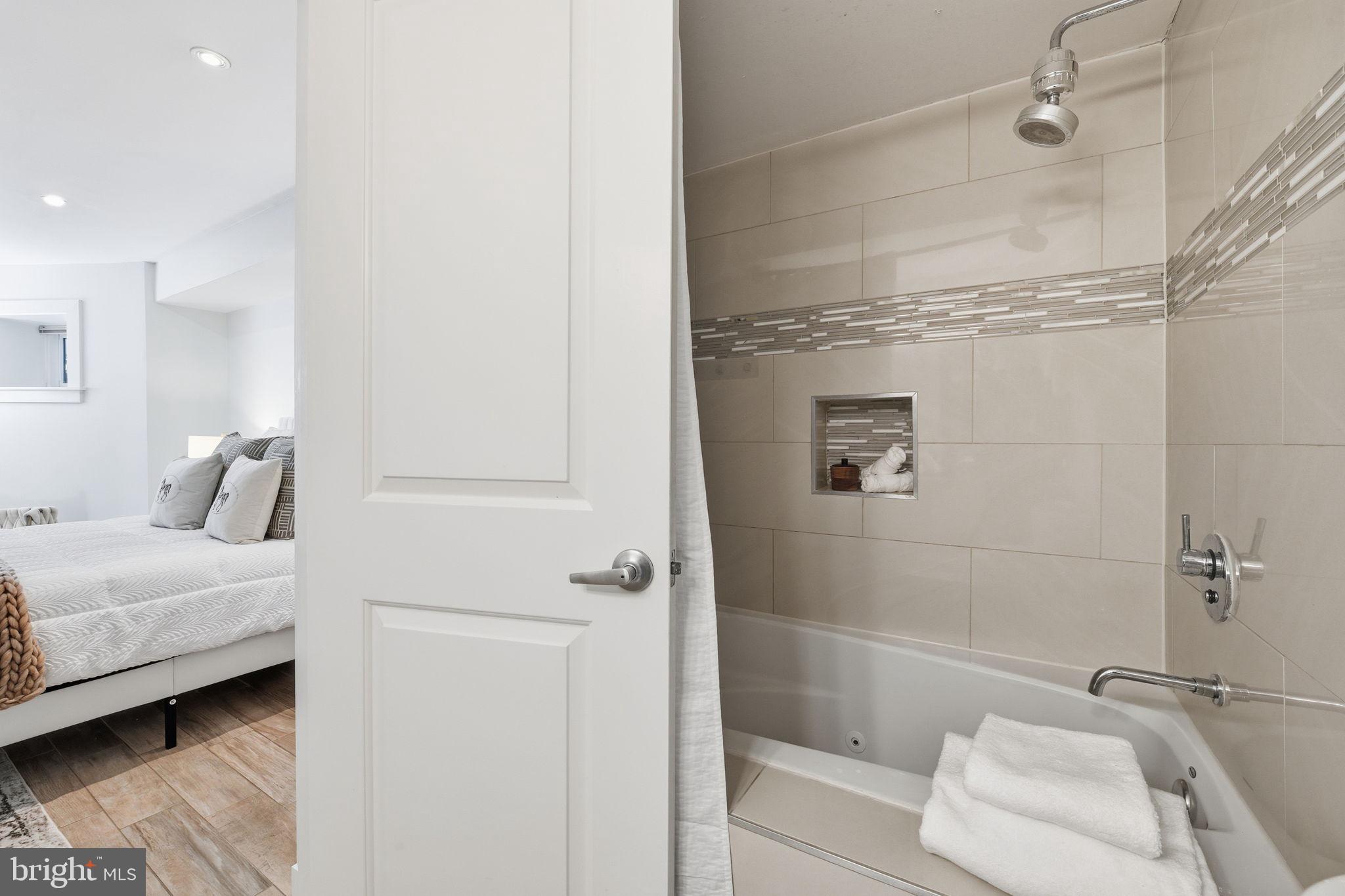 26 Q Street Northeast, Unit 1 Washington, DC 20002 - Photo 26 of 36 a bathroom with a bathtub and shower