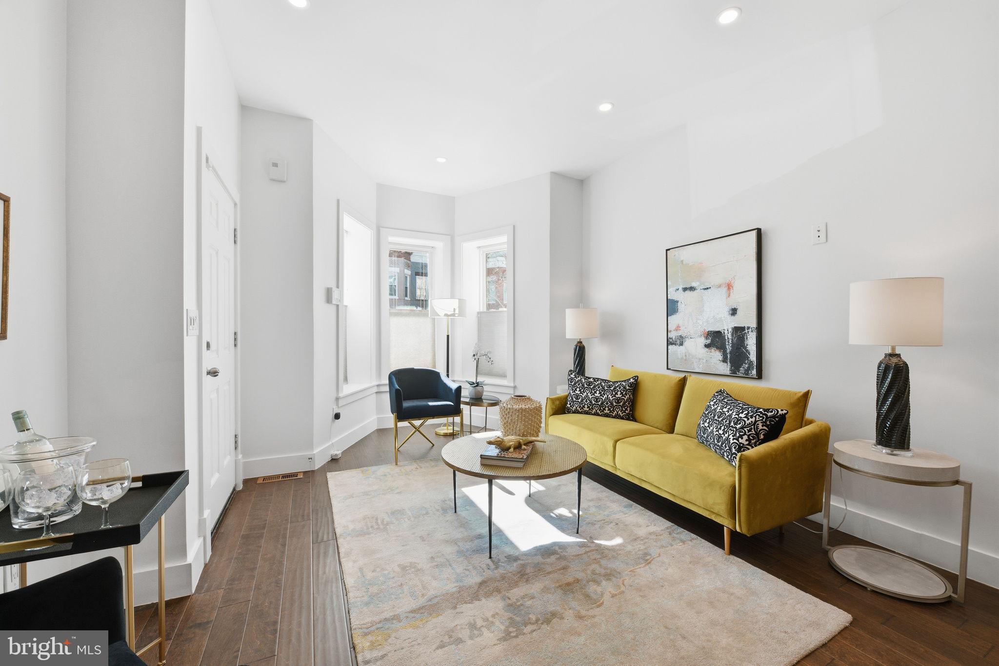 26 Q Street Northeast, Unit 1 Washington, DC 20002 - Photo 3 of 36 a living room with furniture and a table