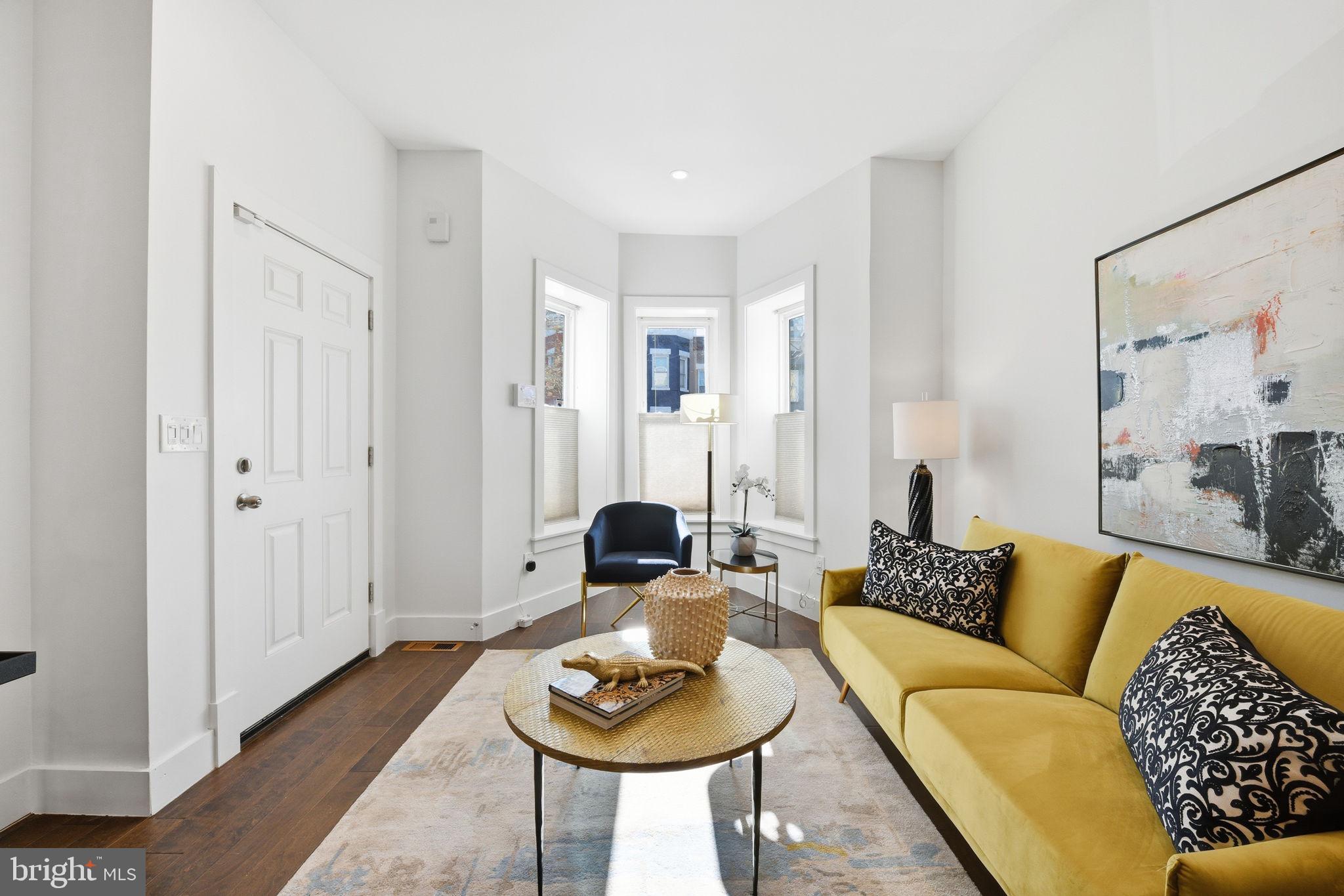 26 Q Street Northeast, Unit 1 Washington, DC 20002 - Photo 4 of 36 a living room with furniture and a potted plant