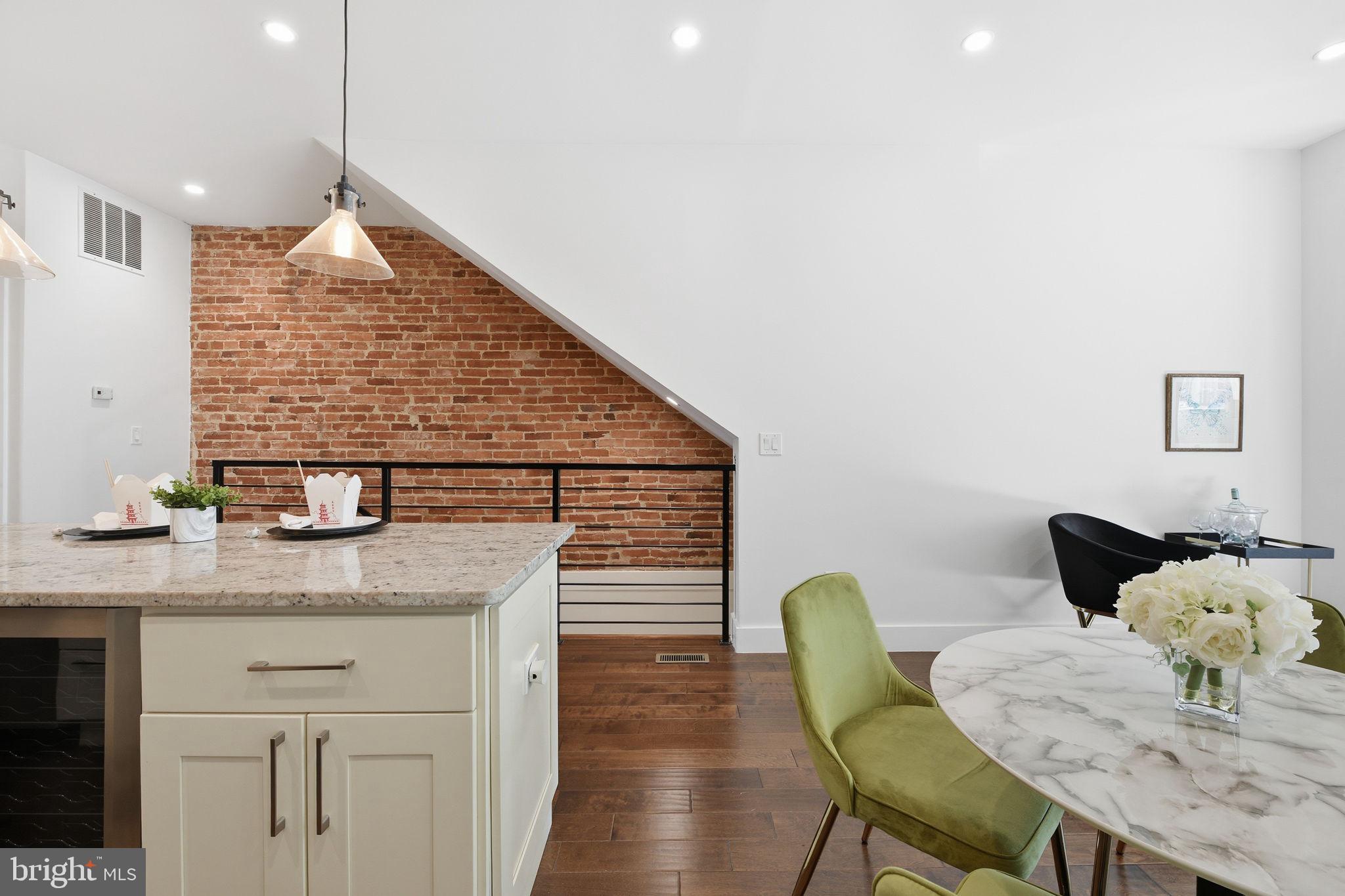 26 Q Street Northeast, Unit 1 Washington, DC 20002 - Photo 7 of 36 a dinning room with dining table chairs and wooden floor