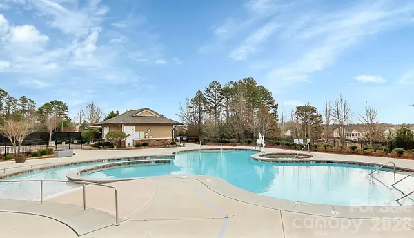 a view of a lake with a house swimming pool and outdoor space