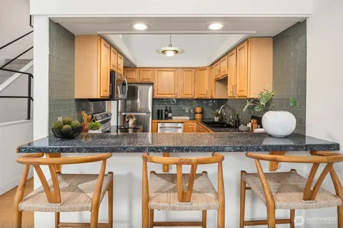 a kitchen with stainless steel appliances granite countertop a sink and a counter top space
