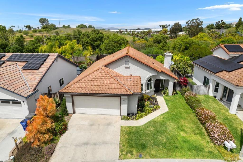 a front view of a house with a yard and trees