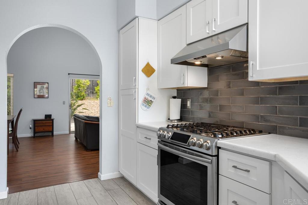 2075 Paseo De Anza Vista, CA 92084 - Photo 19 of 51 a kitchen with a stove cabinets and wooden floor