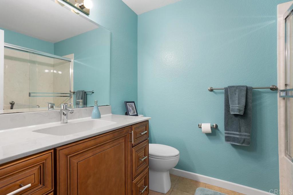 2075 Paseo De Anza Vista, CA 92084 - Photo 21 of 51 a bathroom with a sink a toilet and mirror