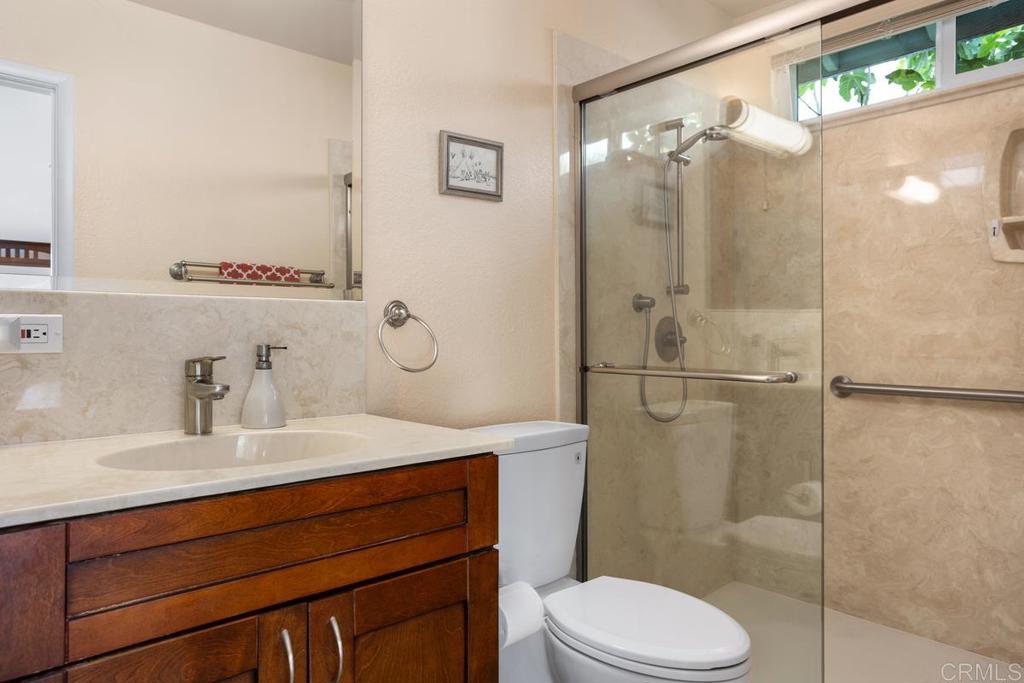 2075 Paseo De Anza Vista, CA 92084 - Photo 28 of 51 a bathroom with a sink vanity mirror and toilet