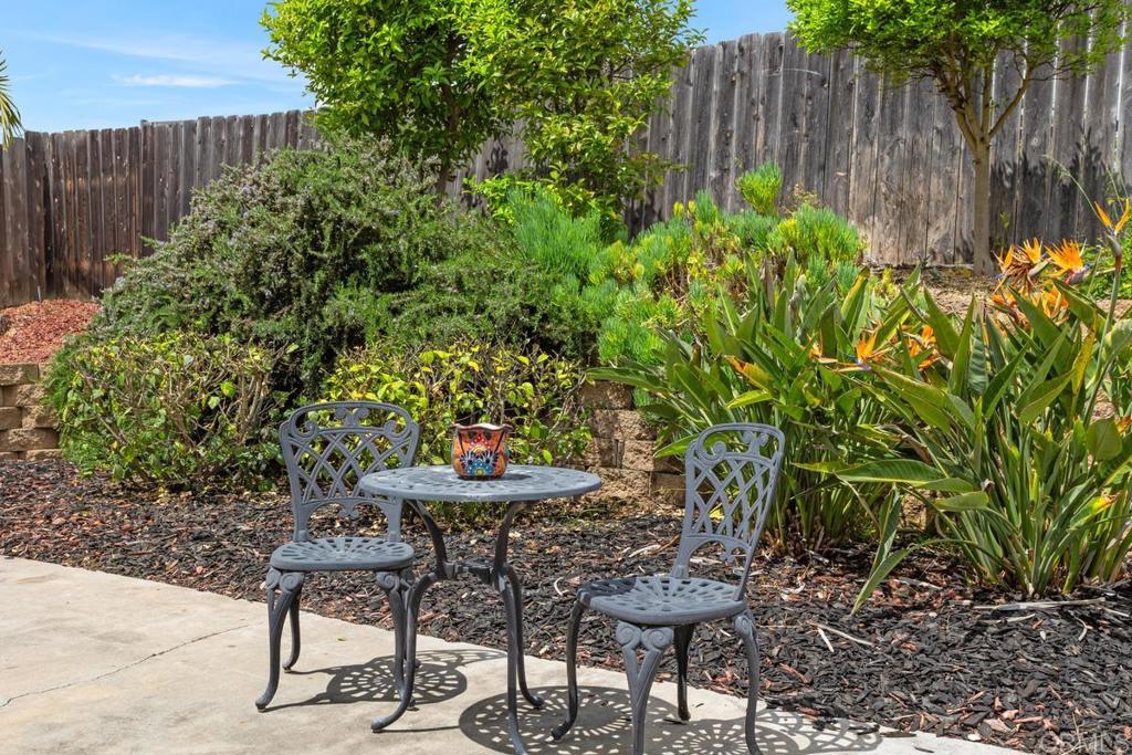 2075 Paseo De Anza Vista, CA 92084 - Photo 30 of 51 a view of a backyard with table and chairs and potted plants