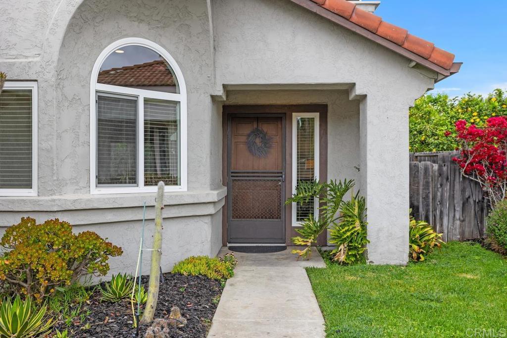 2075 Paseo De Anza Vista, CA 92084 - Photo 3 of 51 a front view of a house with a garden
