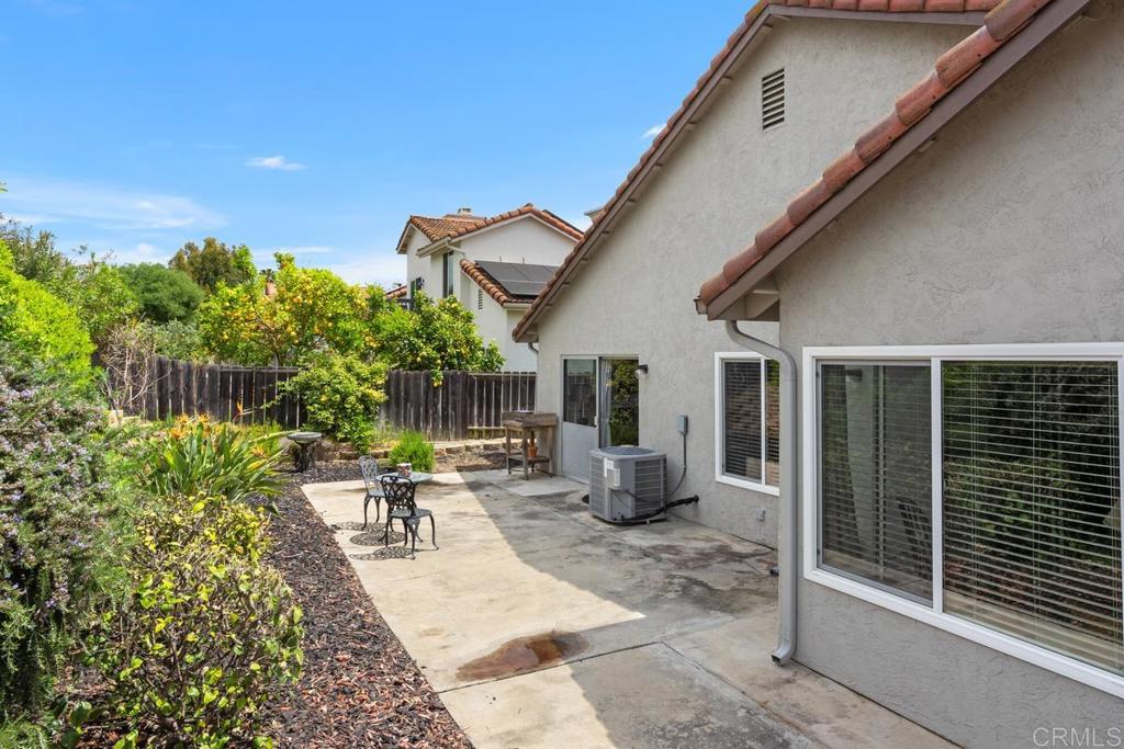 2075 Paseo De Anza Vista, CA 92084 - Photo 32 of 51 a view of a patio with chairs and potted plants