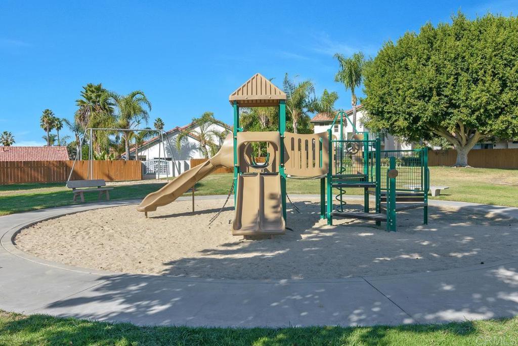 2075 Paseo De Anza Vista, CA 92084 - Photo 43 of 51 a front view of a house with a yard and potted plants