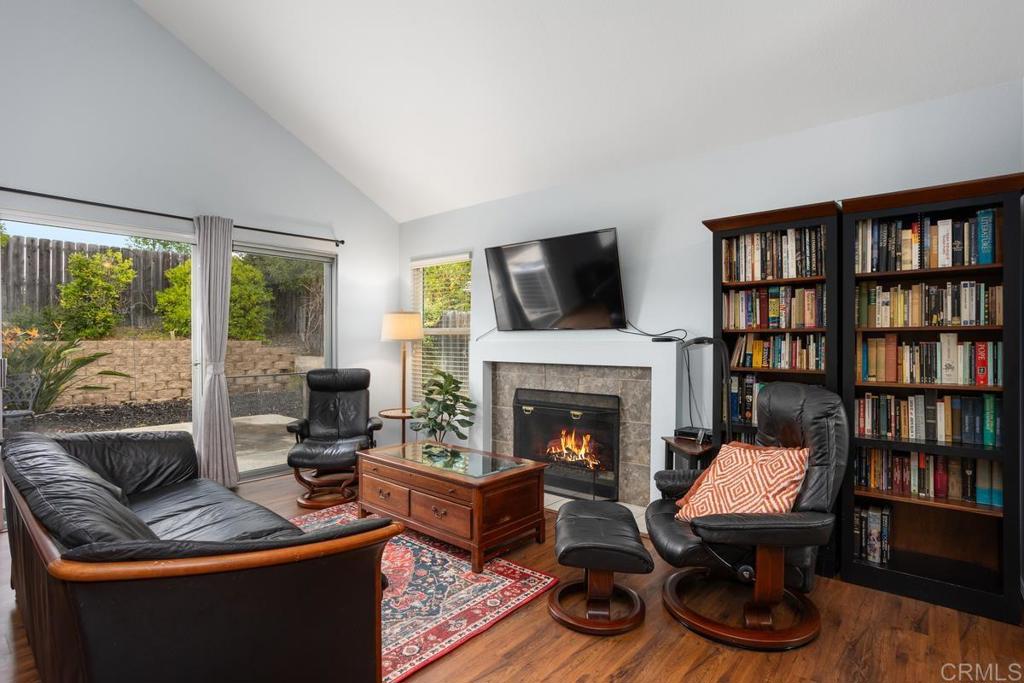 2075 Paseo De Anza Vista, CA 92084 - Photo 7 of 51 a living room with furniture fireplace and a book shelf