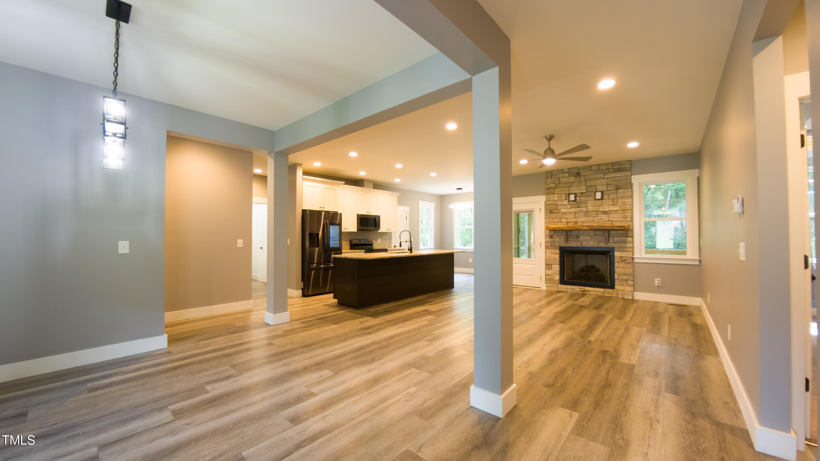 77 Running Deer Path Timberlake, NC 27583 - Photo 10 of 41 a view of a kitchen with kitchen island wooden floor center island and stainless steel appliances