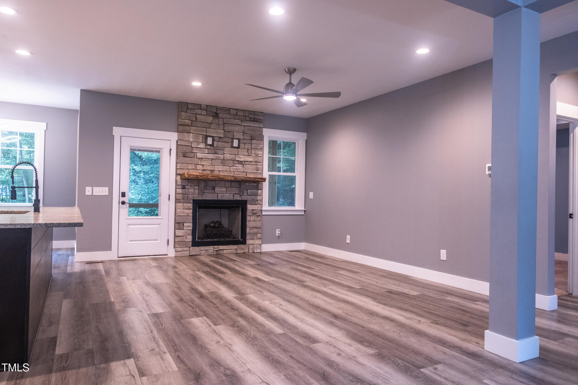 77 Running Deer Path Timberlake, NC 27583 - Photo 11 of 41 a view of an empty room with wooden floor fireplace and a window