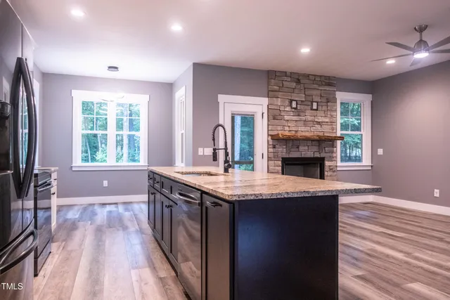 a dining room with furniture a chandelier and wooden floor