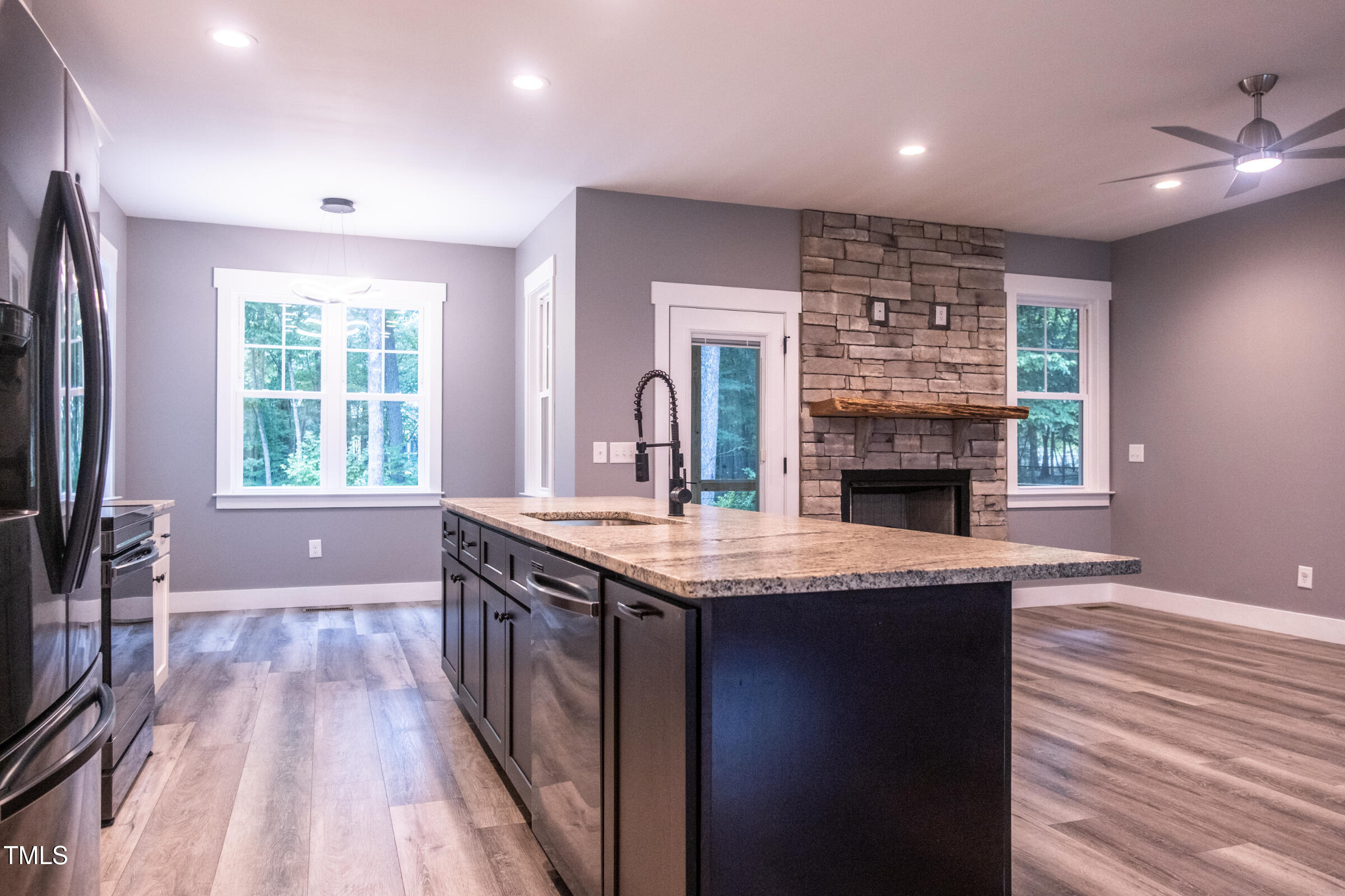 77 Running Deer Path Timberlake, NC 27583 - Photo 16 of 41 a kitchen with kitchen island granite countertop a stove a sink and a refrigerator