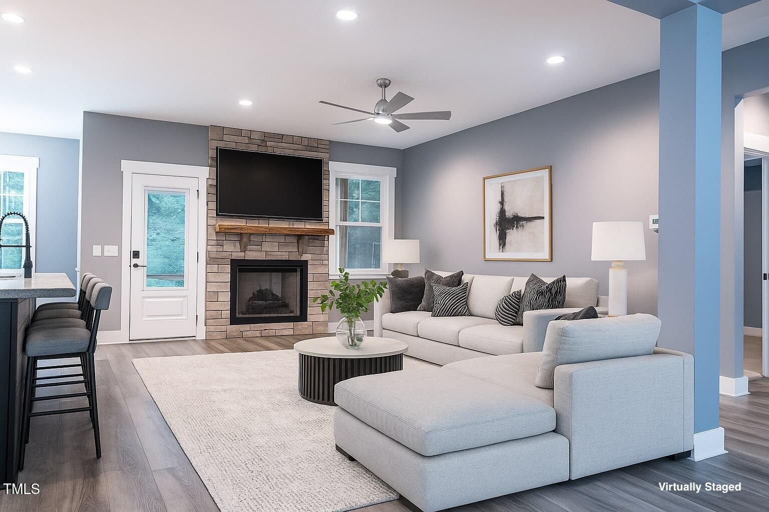 77 Running Deer Path Timberlake, NC 27583 - Photo 17 of 41 a living room with furniture a flat screen tv and a fireplace
