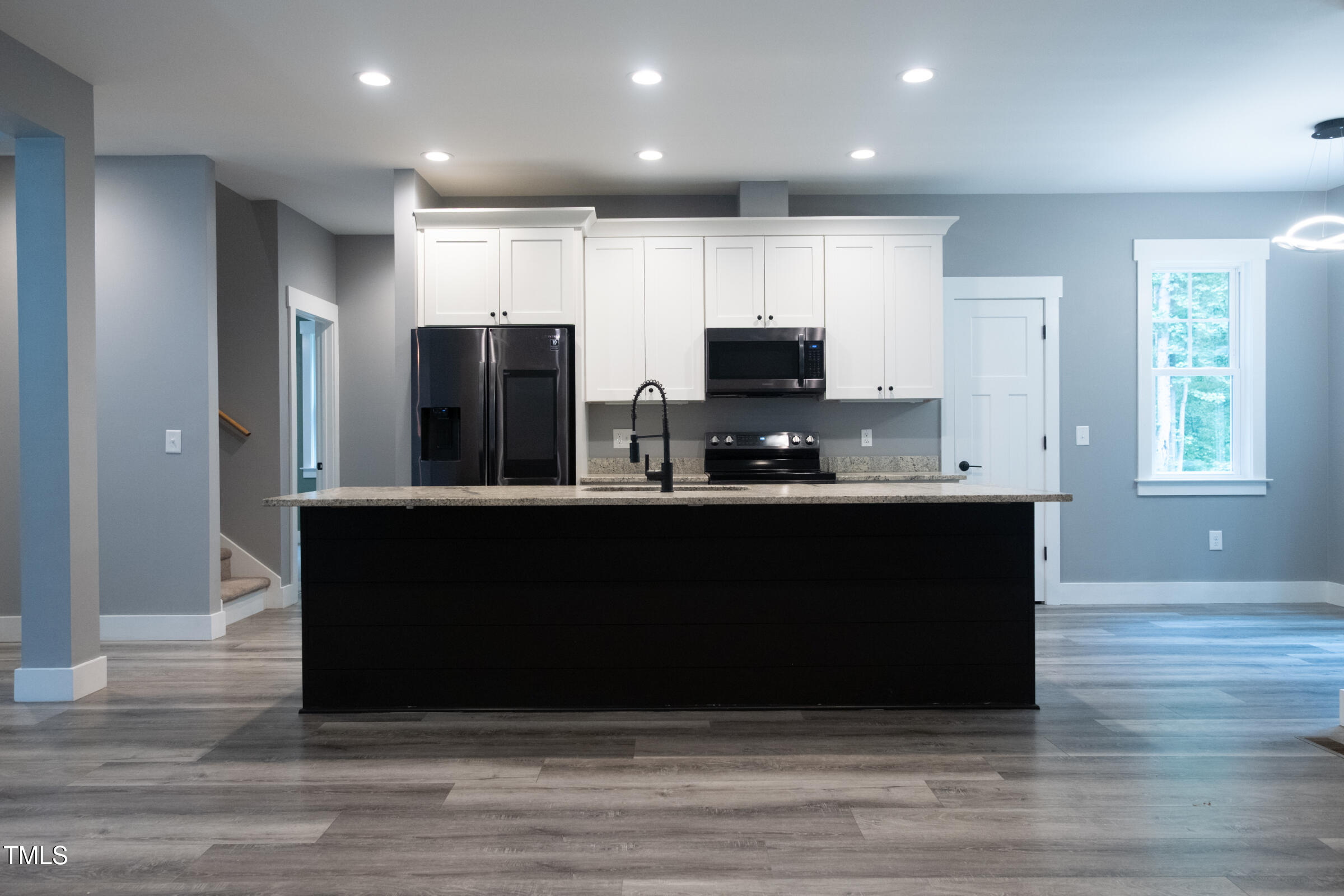 77 Running Deer Path Timberlake, NC 27583 - Photo 18 of 41 a kitchen with kitchen island sink and refrigerator