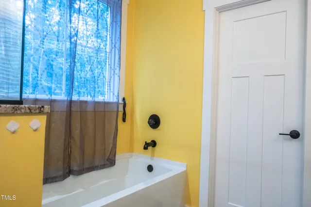 a bedroom with bed and a window