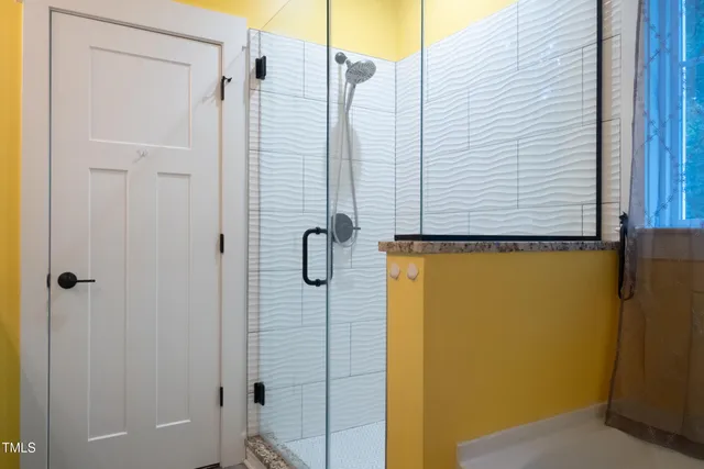 an empty room with a bathroom and a hallway