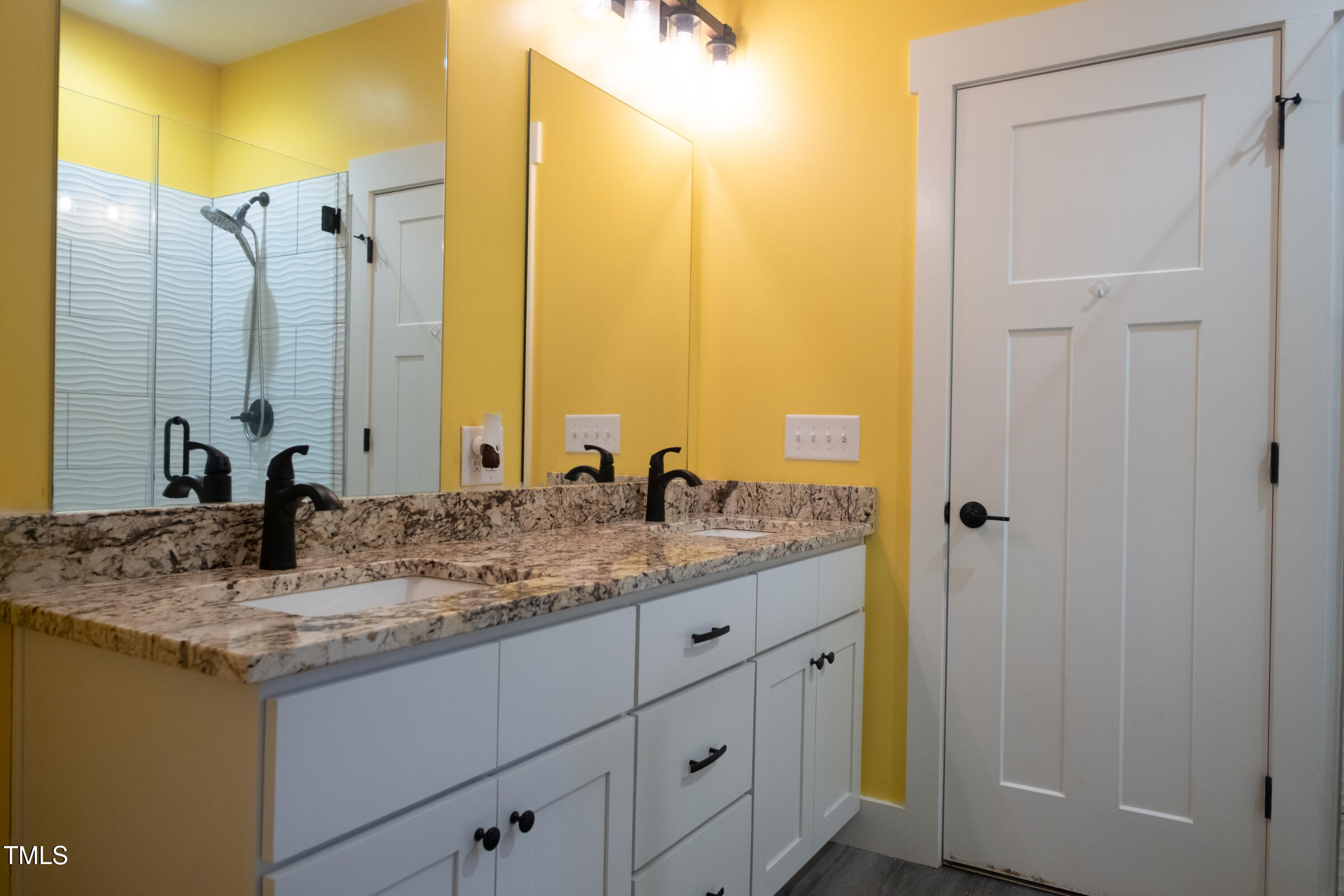 77 Running Deer Path Timberlake, NC 27583 - Photo 24 of 41 a bathroom with a granite countertop sink and a mirror