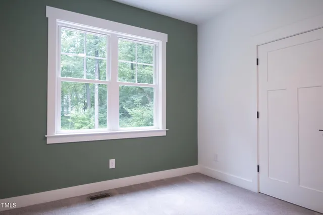 a view of an empty room with closet area